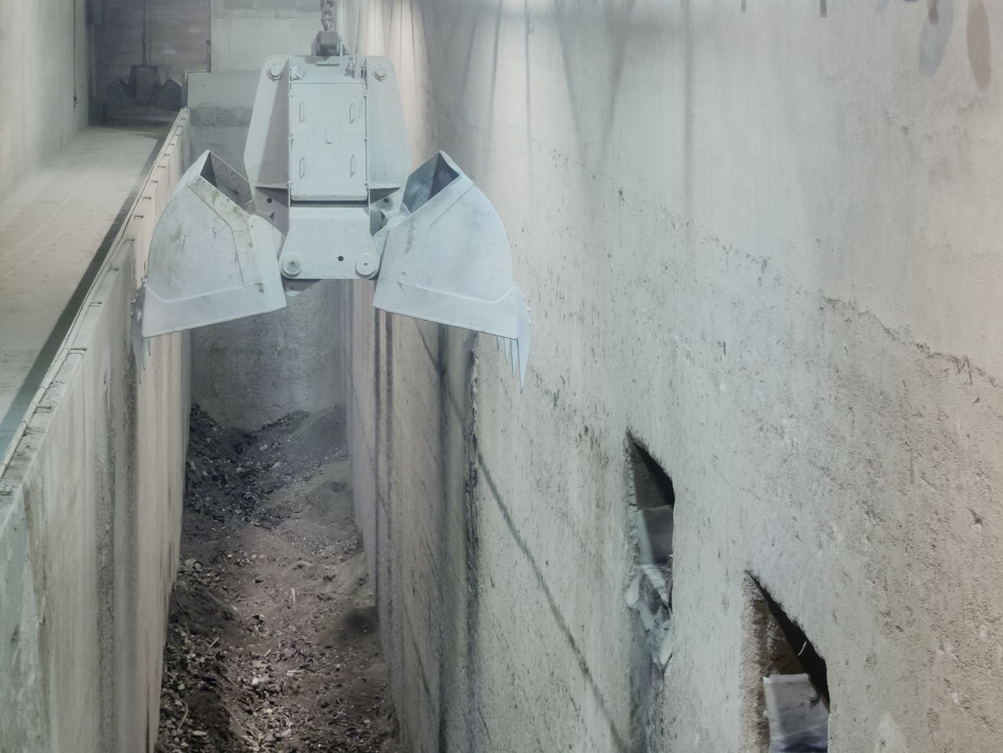 Rostaschebunker Ein schmaler Bunker, in dem Verbrennungsrückstände, sogenannte Rostaschen, lagern. Über dem Bunker ist ein Krangreifer